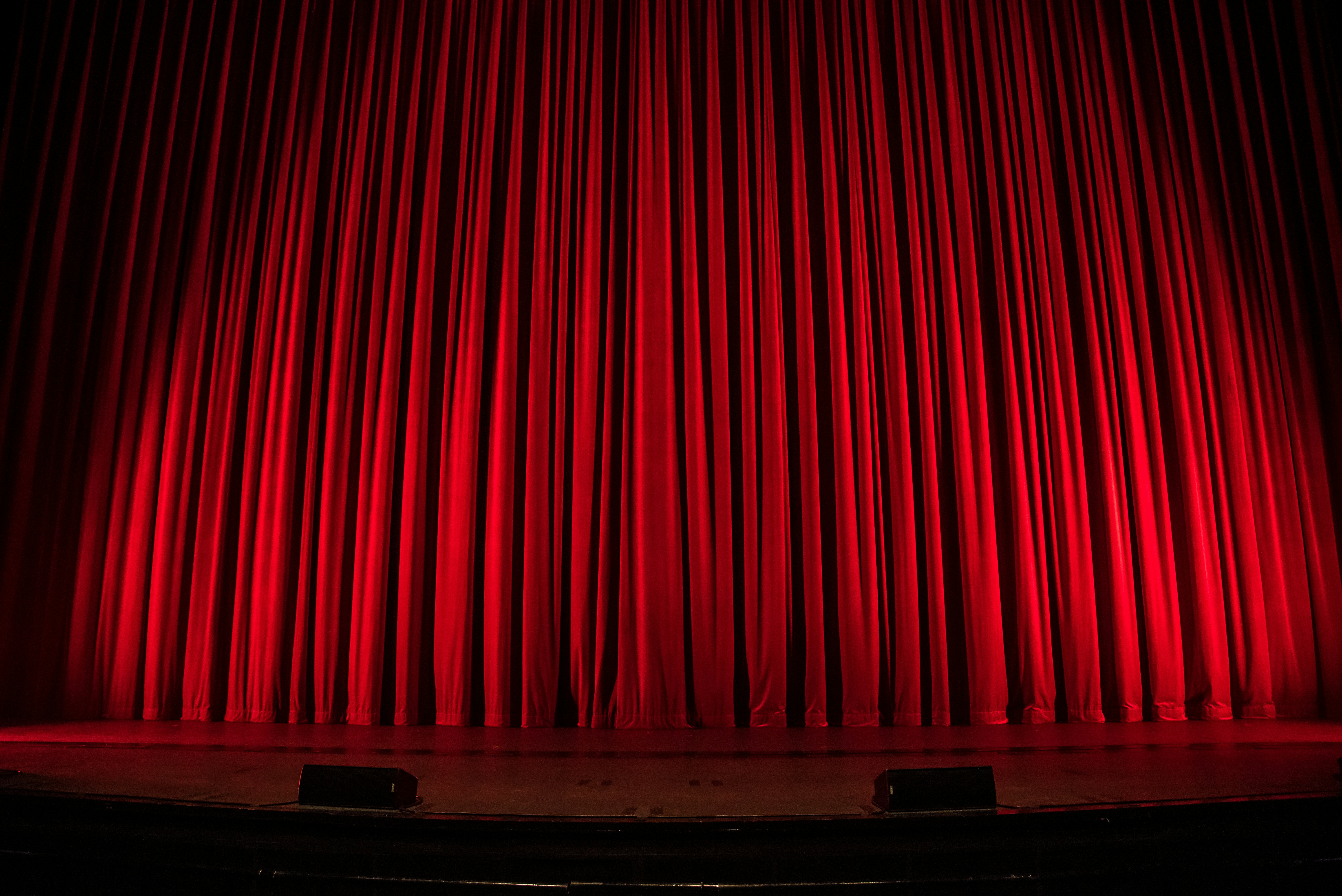 Banner image of a red curtain